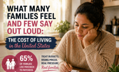 mother looking worried while reviewing monthly bills at a kitchen table, representing the rising cost of living in the United States.