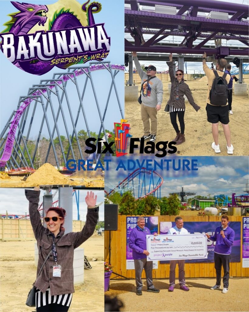 A person poses excitedly with arms raised in front of the Bakunawa sign and roller coaster at Six Flags Great Adventure.