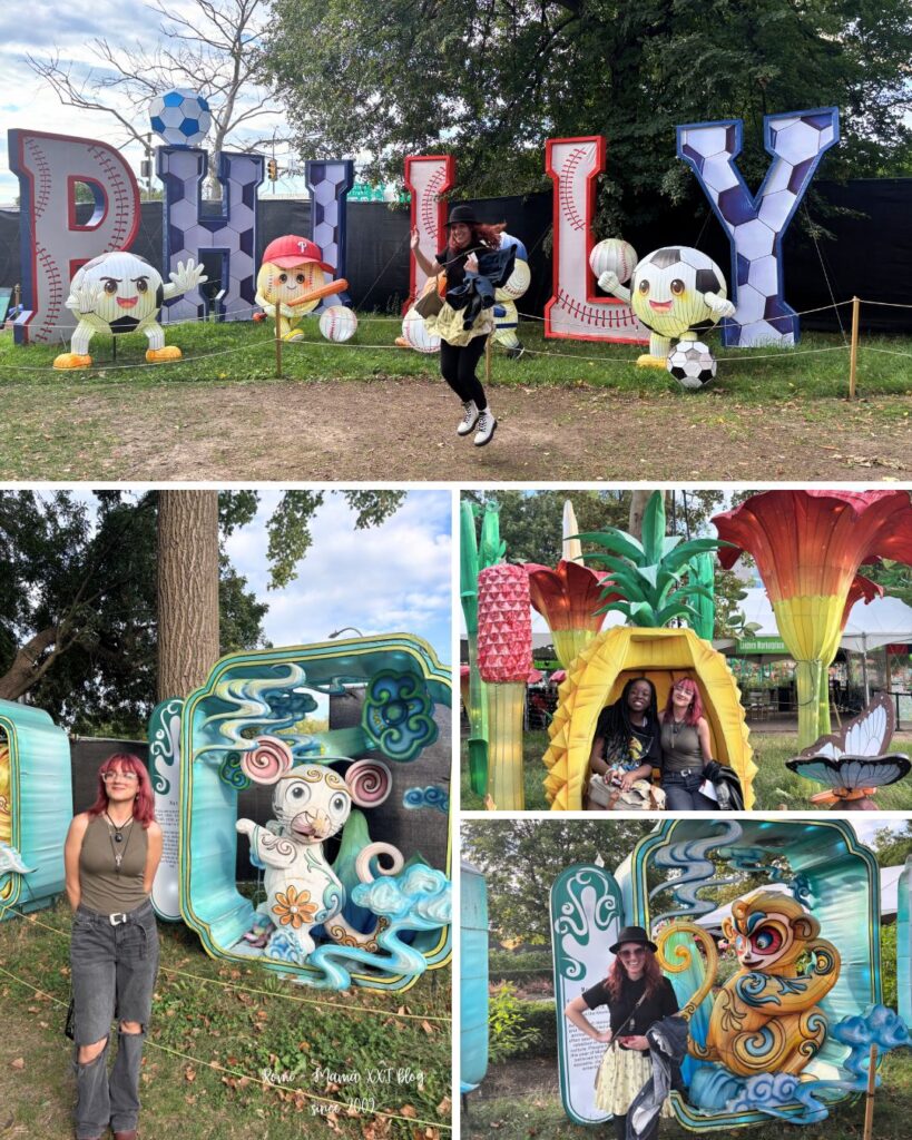 Romina saltando alegremente frente a las letras gigantes de "PHILLY" rodeada de coloridas estatuas y decoraciones de fútbol, con las grandes flores de loto luminosas y los faroles del festival de fondo en Franklin Square.